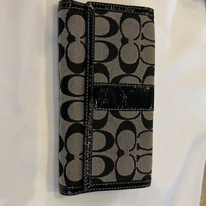 Coach wallet with lavender accent color.  Good condition. Zippered side.